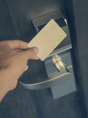 A hotel keycard tapped on electronic lock.